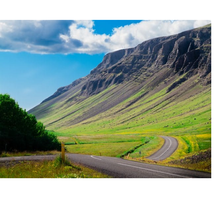long road and mountain range in iceland